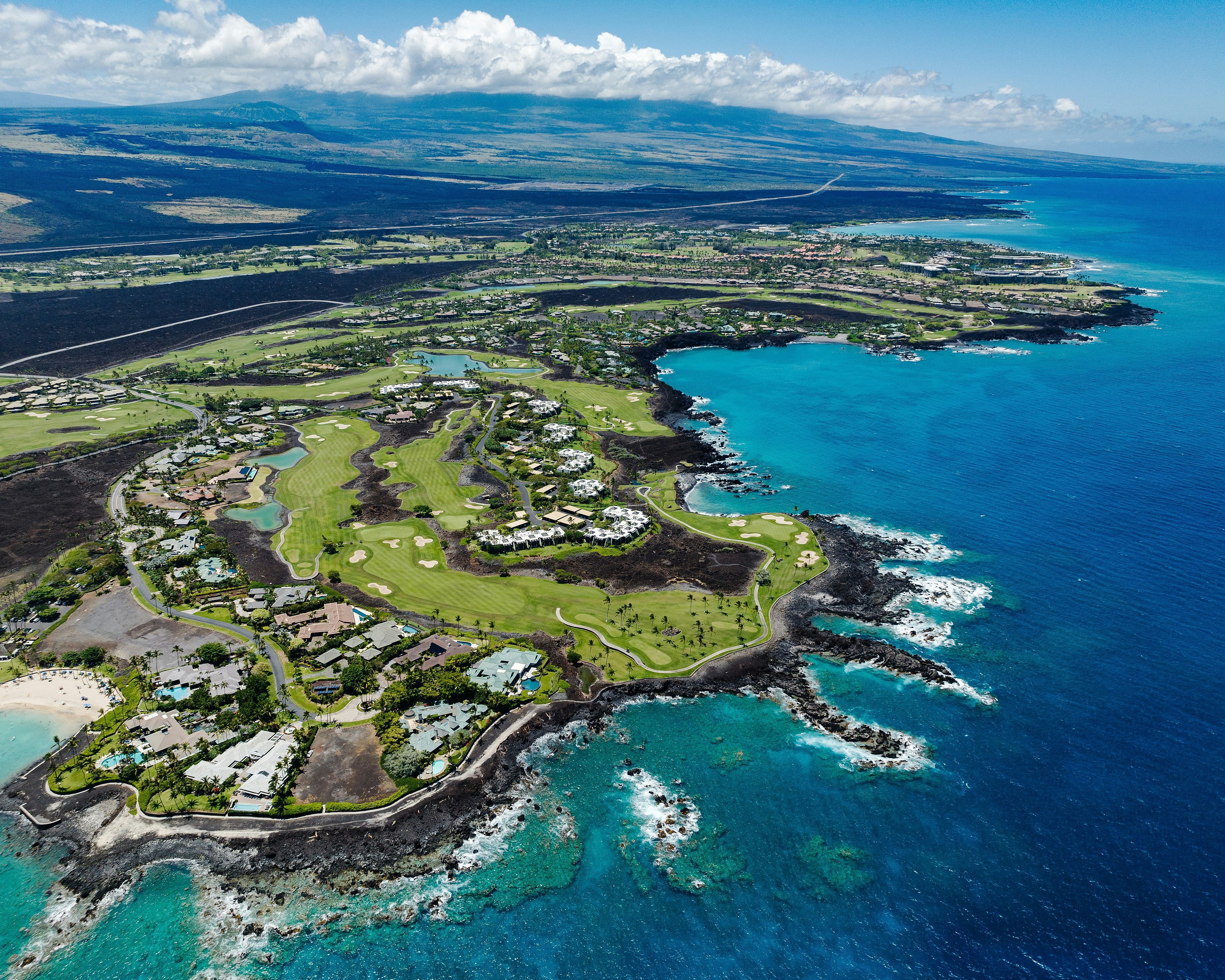 Aerial view of an oceanfront golf resort on the coast of Hawaii's Big Island